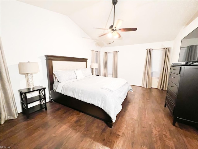 bedroom featuring dark hardwood / wood-style flooring, lofted ceiling, and ceiling fan