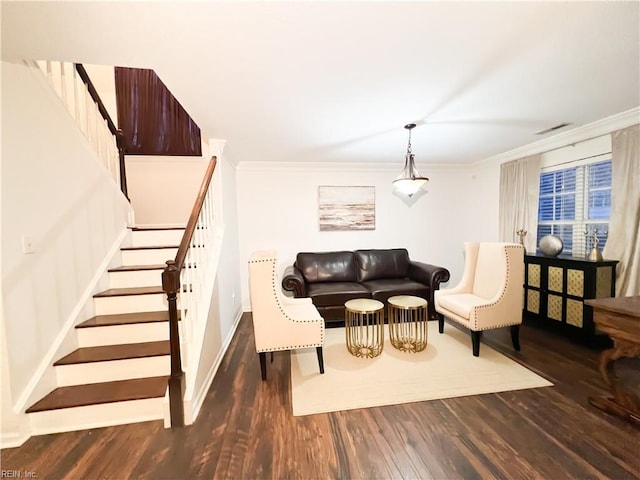 living room with dark hardwood / wood-style flooring and ornamental molding