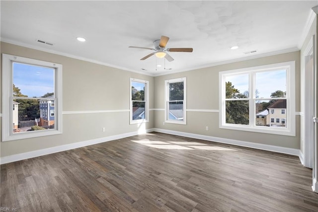 spare room with ornamental molding, dark hardwood / wood-style floors, and a healthy amount of sunlight