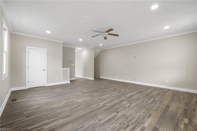 spare room with crown molding, ceiling fan, a healthy amount of sunlight, and dark hardwood / wood-style flooring