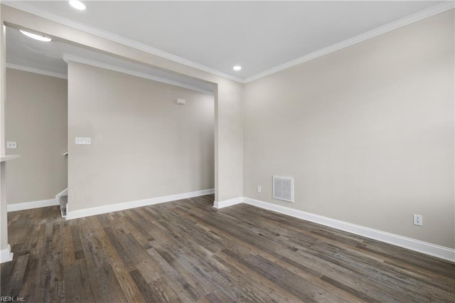 empty room featuring crown molding and dark wood-type flooring