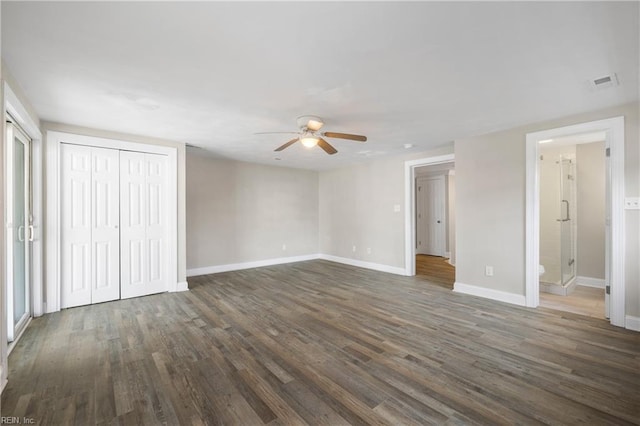 unfurnished bedroom featuring ceiling fan, dark hardwood / wood-style flooring, and ensuite bath