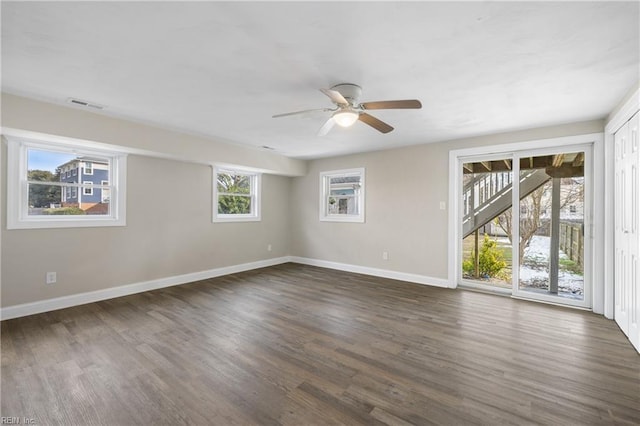 unfurnished room with ceiling fan and dark hardwood / wood-style flooring