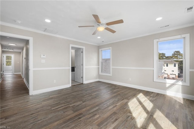 spare room with crown molding, ceiling fan, a healthy amount of sunlight, and dark hardwood / wood-style flooring