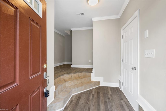 entrance foyer featuring hardwood / wood-style flooring and ornamental molding