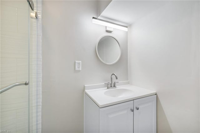 bathroom with vanity and a shower with door