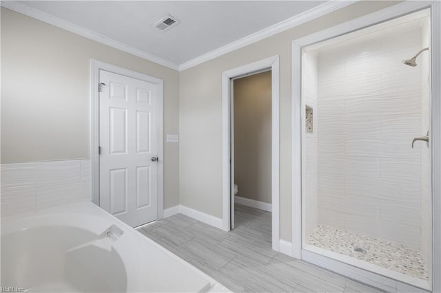 bathroom with toilet, ornamental molding, and plus walk in shower