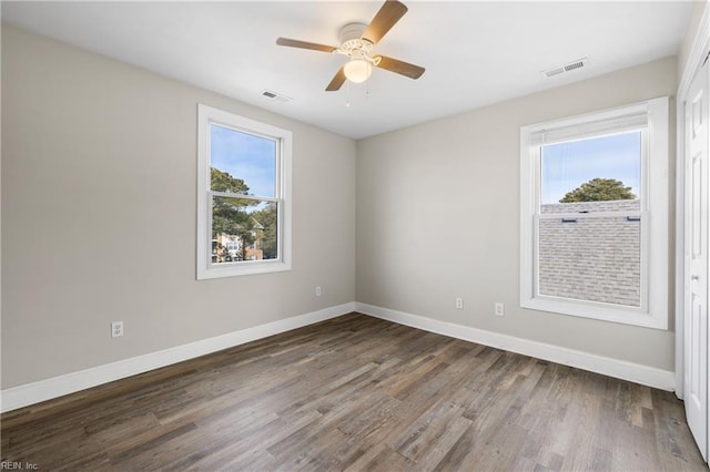 spare room featuring hardwood / wood-style flooring, ceiling fan, and a wealth of natural light