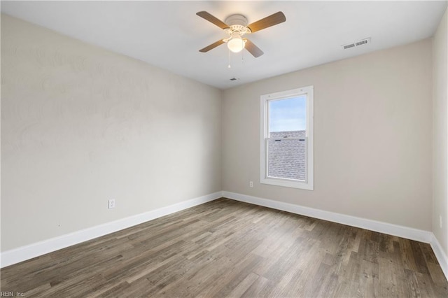 empty room with hardwood / wood-style flooring and ceiling fan