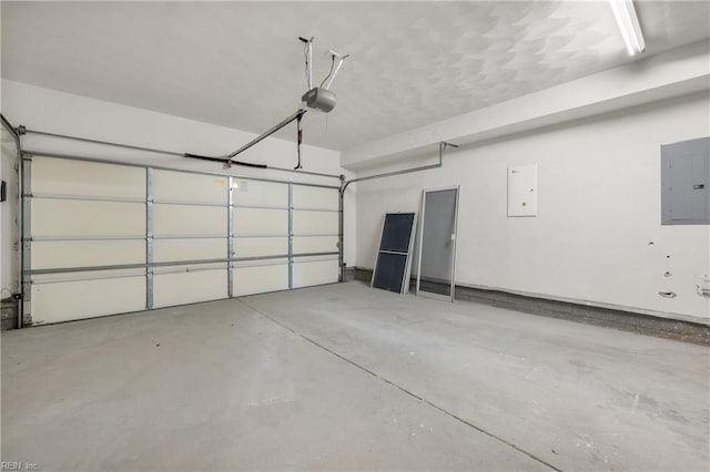 garage with a garage door opener and electric panel