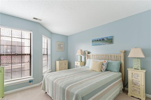 carpeted bedroom with a textured ceiling