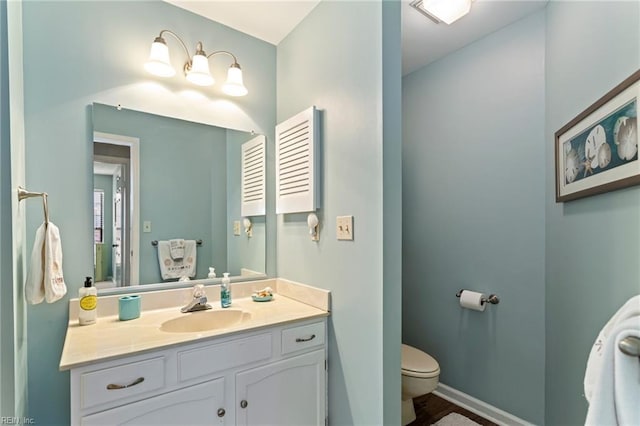 bathroom featuring vanity and toilet