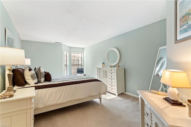 carpeted bedroom featuring a textured ceiling