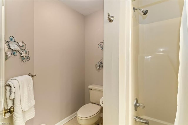 bathroom with washtub / shower combination and toilet