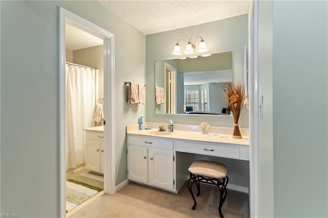 bathroom with vanity and a textured ceiling