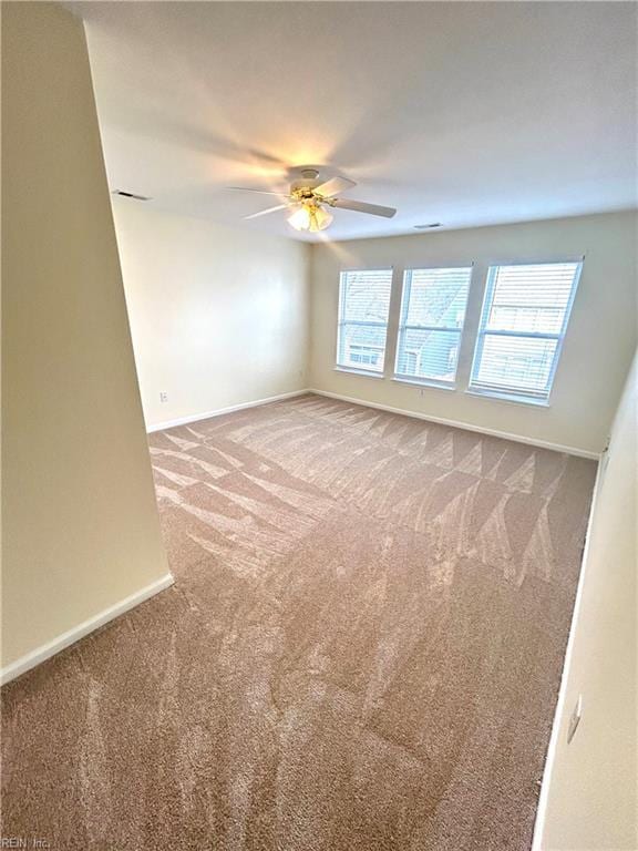 unfurnished room featuring carpet floors and ceiling fan