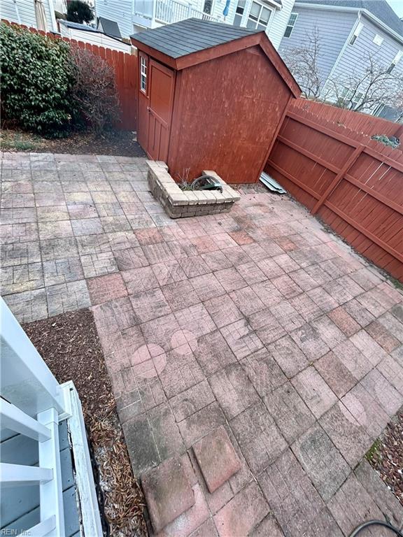 view of patio featuring a storage shed