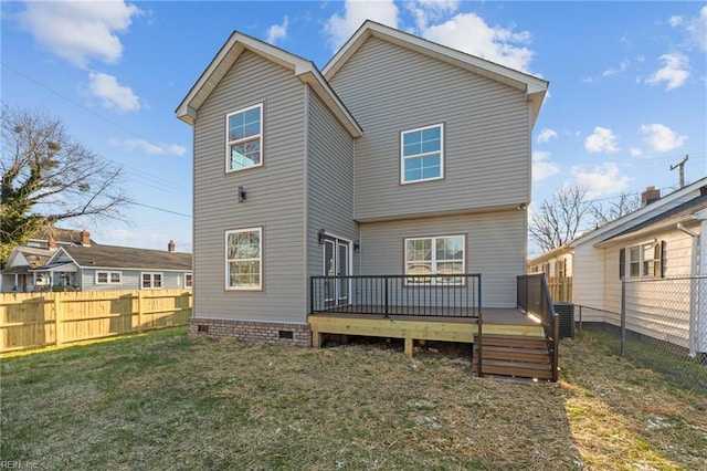 back of property featuring central air condition unit, a deck, and a lawn