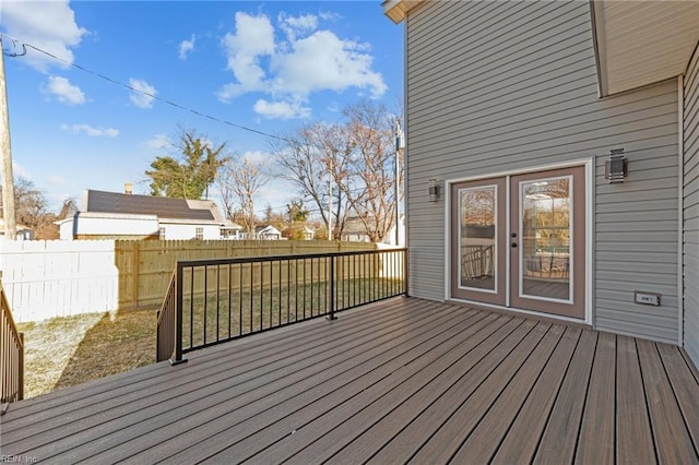 wooden terrace with a yard and french doors