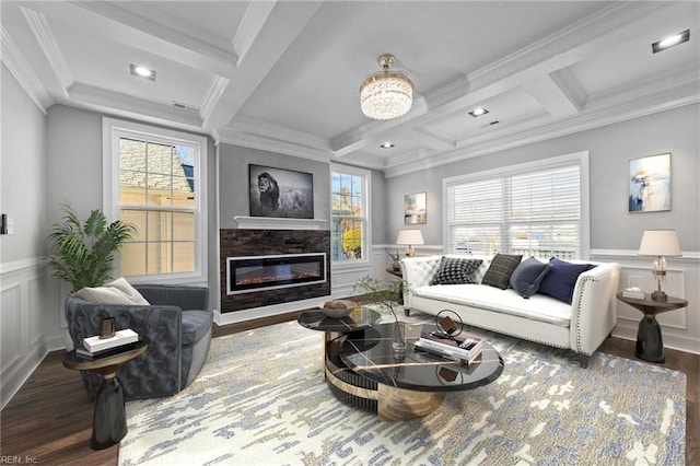 living room with crown molding, coffered ceiling, a chandelier, beam ceiling, and dark wood-type flooring