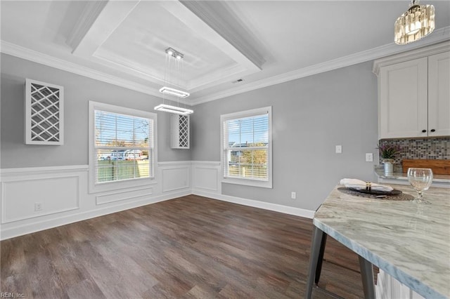 dining room with crown molding, a healthy amount of sunlight, dark hardwood / wood-style flooring, and a raised ceiling