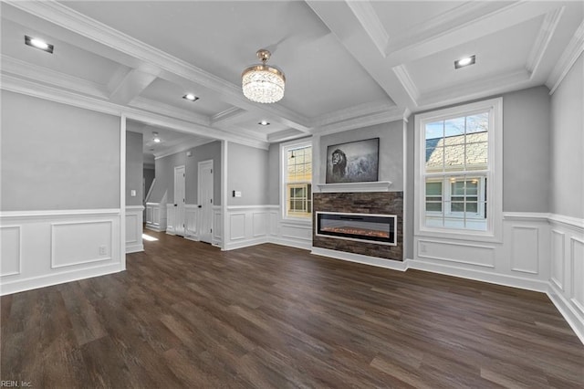 unfurnished living room featuring ornamental molding, coffered ceiling, a stone fireplace, and beam ceiling