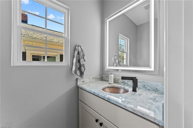 bathroom with vanity and a healthy amount of sunlight