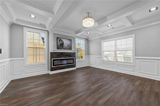 unfurnished living room featuring ornamental molding, a stone fireplace, beam ceiling, and dark wood-type flooring