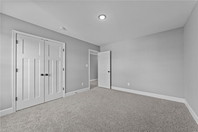 unfurnished bedroom with a closet and carpet