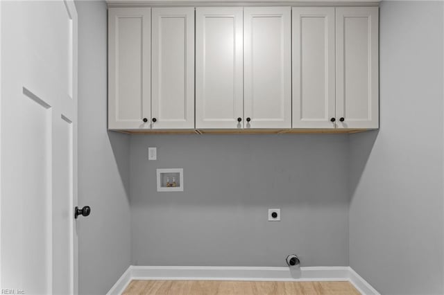 laundry area featuring washer hookup, electric dryer hookup, and cabinets