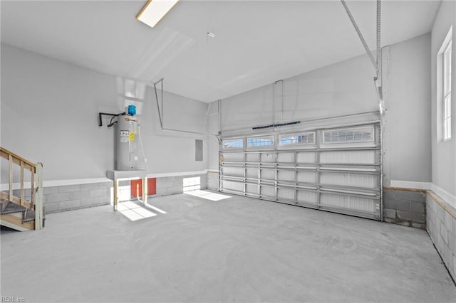 garage featuring electric panel and electric water heater