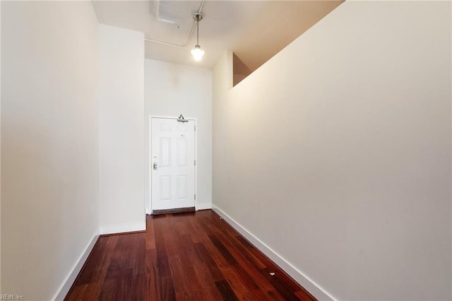 hallway with dark hardwood / wood-style flooring