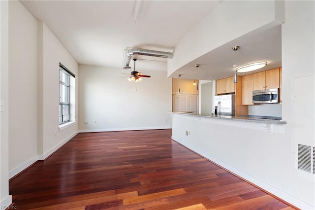 unfurnished living room featuring dark hardwood / wood-style floors and ceiling fan