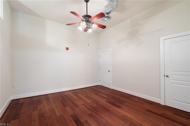 empty room with dark wood-type flooring and ceiling fan