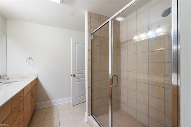 bathroom with tile patterned flooring, vanity, and walk in shower