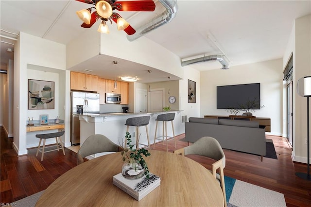 dining room featuring dark hardwood / wood-style floors and ceiling fan