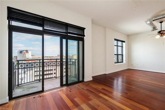 empty room with hardwood / wood-style flooring and ceiling fan