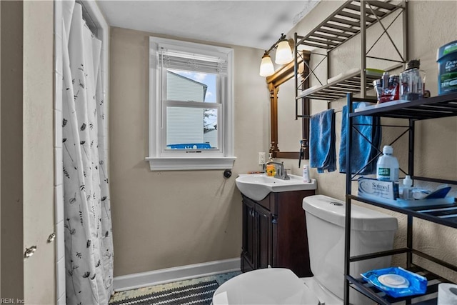 bathroom with vanity, toilet, and a shower with shower curtain