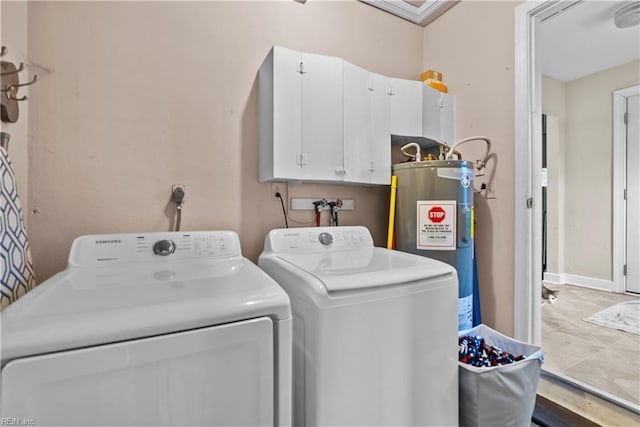 laundry room featuring cabinets, electric water heater, and washing machine and clothes dryer