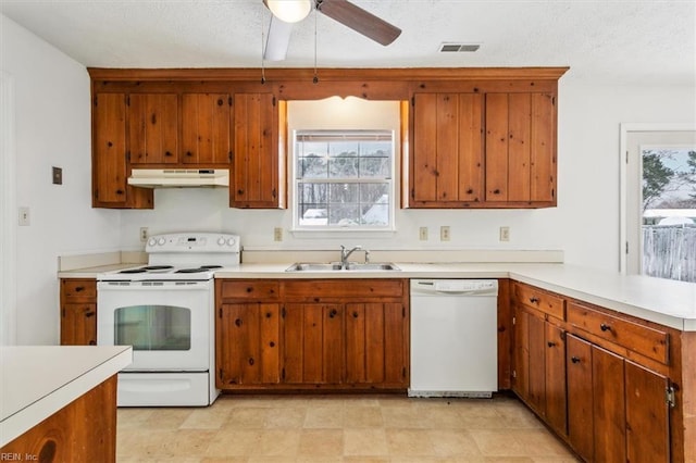 kitchen with ceiling fan, sink, a textured ceiling, and white appliances