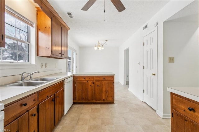 kitchen featuring dishwasher, sink, a wealth of natural light, and kitchen peninsula