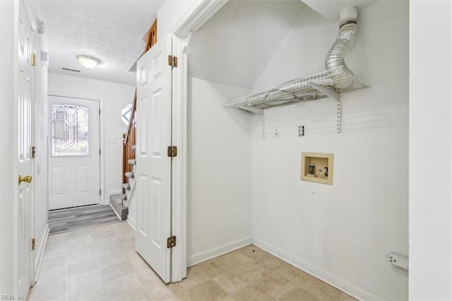 laundry area featuring hookup for a washing machine and a textured ceiling