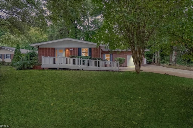 ranch-style home featuring covered porch and a front lawn