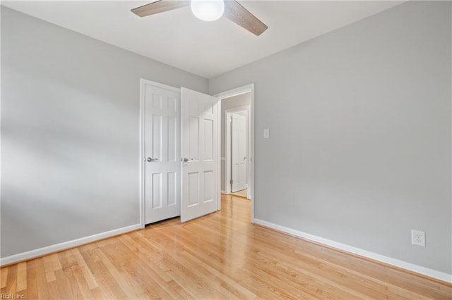 unfurnished bedroom with ceiling fan and light wood-type flooring