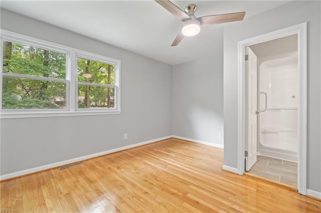 unfurnished bedroom with ceiling fan and light wood-type flooring