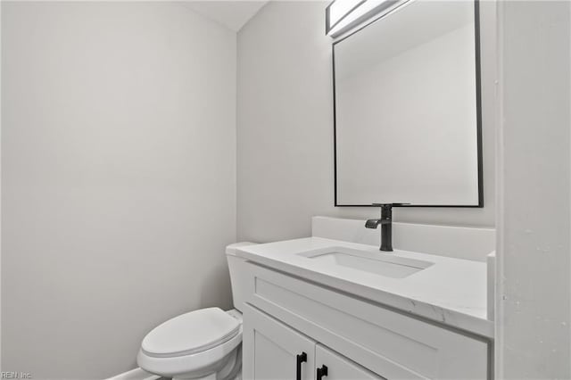 bathroom featuring toilet and vanity