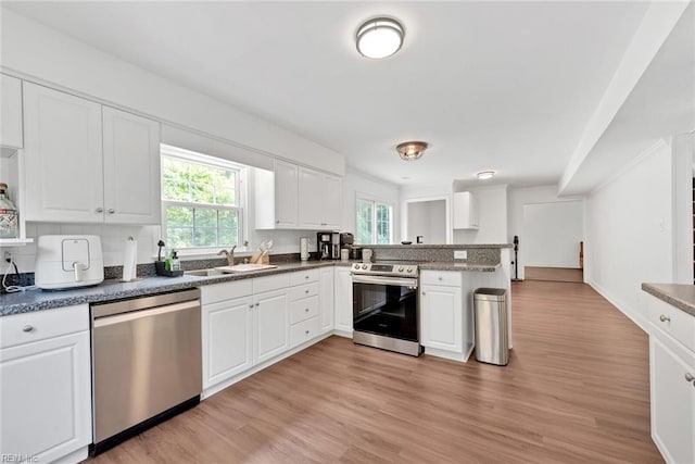 kitchen featuring sink, white cabinets, and appliances with stainless steel finishes