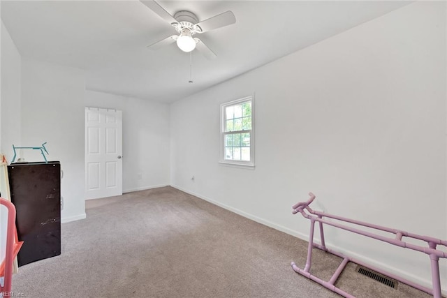 unfurnished room with light carpet and ceiling fan