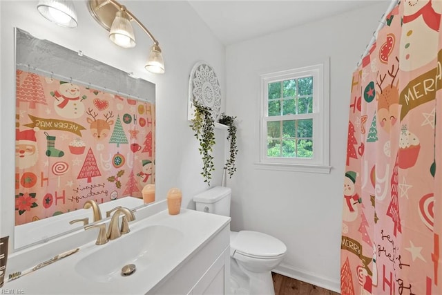 bathroom with wood-type flooring, toilet, vanity, and a shower with curtain