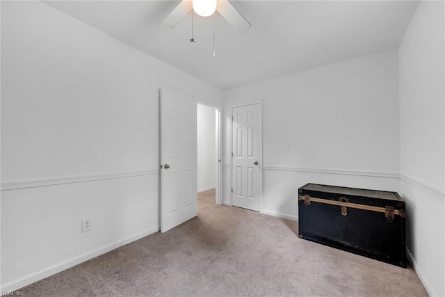 unfurnished bedroom with ceiling fan and light colored carpet